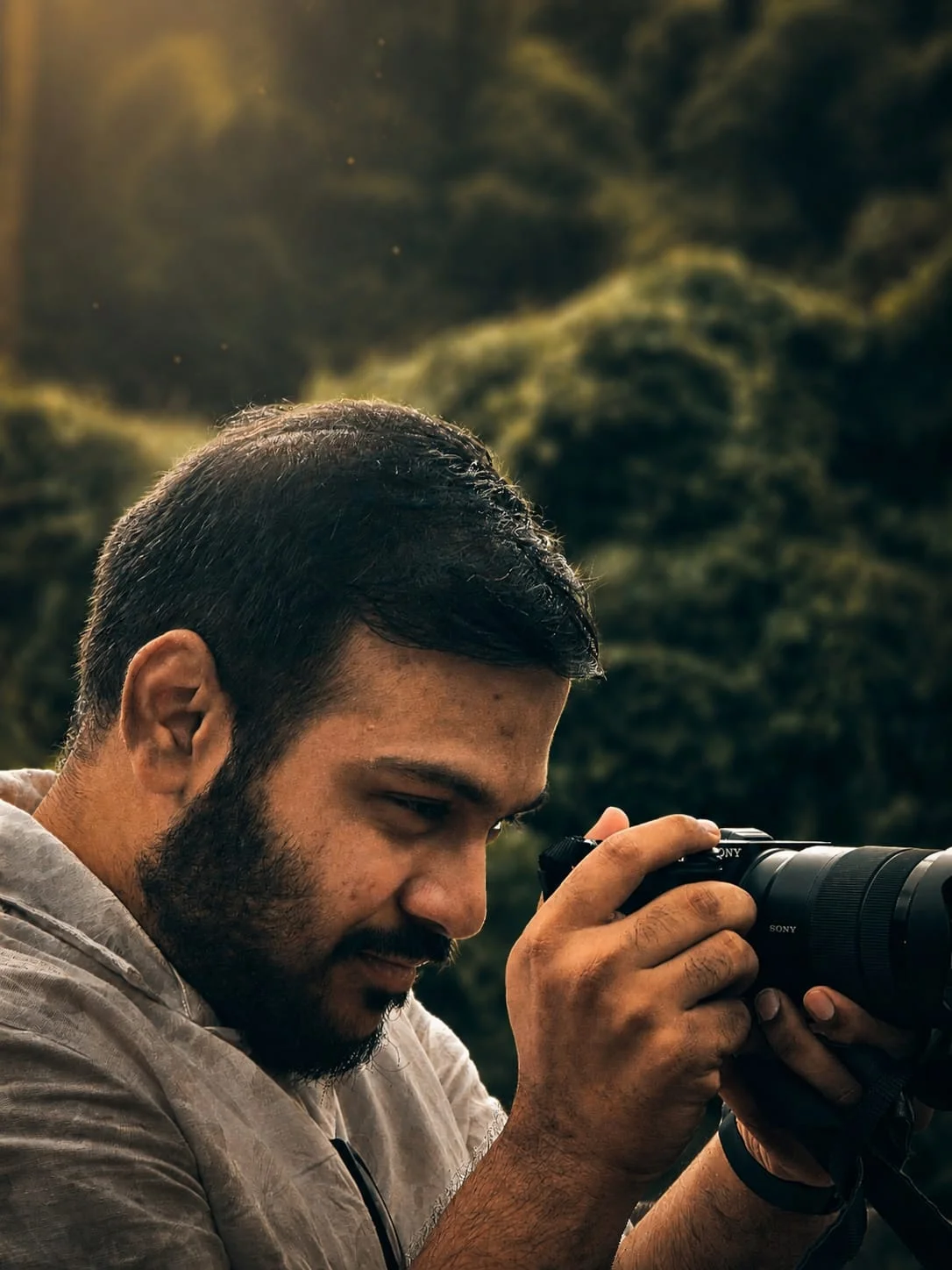 Dyutik looking through his Sony camera outdoors